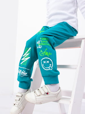 Штани спортивні бірюзового кольору з принтом | 6132017
