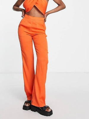 Штани помаранчевого кольору з кльошем штанин донизу | 6698849