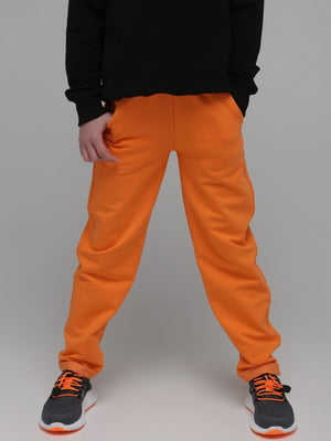 Спортивні штани помаранчевого кольору | 6740907