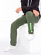 Штани спортивні зелені з принтом | 6078672