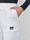 Трикотажные штаны молочного цвета на флисе с накладными карманами | 6547821 | фото 4