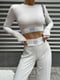 Белый трикотажный костюм в рубчик с топом и брюками | 6570235 | фото 2
