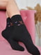 Шкарпетки махрові чорного кольору з малюнком | 6577588 | фото 2