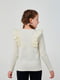 Блуза молочного кольору, прикрашена мереживом та атласним бантиком. | 6618849 | фото 4