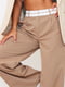 Бежеві штани вільного крою з легкої тканини та білим поясом | 6700539 | фото 4
