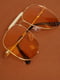Сонцезахисні окуляри помаранчевого кольору із золотистою оправою | 6700568 | фото 2