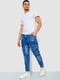 Сині джинси з потертостями та накладними кишенями | 6812522 | фото 2