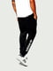 Спортивные черные брюки с фирменной надписью | 6817471 | фото 2
