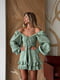 Зелена сукня міні з мусліну в квітковий принт з регульованою збіркою на грудях та широкими об”ємними рукавами | 6858667 | фото 6